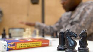 CONTINGENCY OPERATING BASE ADDER, Iraq - 1st Lt. Shelby Johnson, the executive officer of B Company, 3rd Brigade Special Troops Battalion, 3rd Advise and Assist Brigade, 1st Cavalry Division, plays a game of chess with a friend on Contingency Operating Base Adder May 3. Johnson has played the game for 26 years and will participate in this year's All Army Chess Championship.