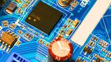 A photo of a printed circuit board shows a chip with "CHINA" written on it