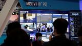 An employee of the Chinese AI firm Megvii speaks during an organized media tour to the Zhongguancun National Innovation Demonstration Zone Exhibition Center in Beijing, China, February 10, 2022., photo by Florence Lo/Reuters
