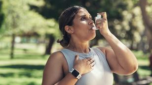 A woman outside using an inhaler for asthma, photo by PeopleImages/Getty Images