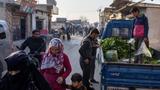 People walk along a street at a refugee camp in Idlib, Syria, December 17, 2024, photo by Umit Bektas/Reuters