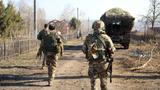 Russian service members walk along a street in a part of the Kursk region, which was recently retaken by Russia's armed forces in this image released March 14, 2025, photo by Russian Defence Ministry/Handout via Reuters